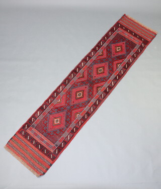 A red and blue ground Meshwani runner with 4 diamonds to the centre 237cm x 57cm 
