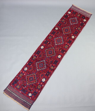 A red and blue ground Meshwani runner with 6 diamonds to the centre 262cm x 60cm 