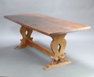 A 17th Century style oak refectory dining table raised on pierced standard end supports with H framed stretcher 74cm h x 198cm l x 83cm w 