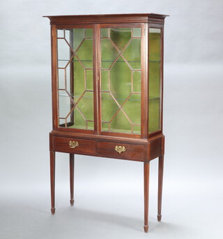 An Edwardian Chippendale style mahogany display cabinet interior fitted shelves enclosed by astragal glazed panelled doors, base fitted 2 drawers with brass swan neck drop handles, raised on square tapered supports, spade feet 168cm h x 97cm w x 35cm d 