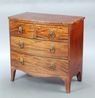 A Georgian mahogany bow front chest of 2 short and 2 long drawers with brass lion mask drop handles, raised on bracket feet 93cm h x 92cm w x 55cm d 