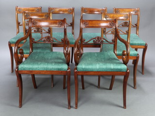 A set of 8 Regency carved mahogany bar back dining chairs with pierced midrails and upholstered drop in seats, 6 standard, 2 carver, raised on sabre supports, 