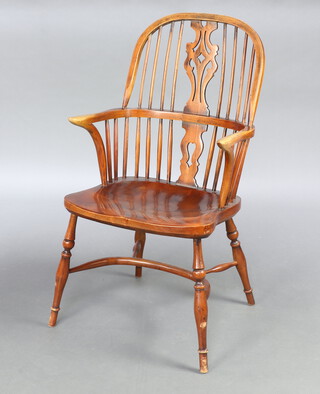 A 19th/20th Century elm stick back Windsor kitchen carver chair with solid elm seat and crinoline stretcher, raised on turned supports 103cm h x 54cm w x 46cm d (seat 32cm x 30cm)   