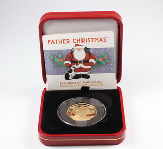 A Father Christmas proof 22ct gold piedfort 50 pence boxed and with certificate 