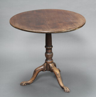 A circular Georgian mahogany snap top tea table raised on turned column and tripod base with egg and claw feet 70cm h x 76cm diam. 