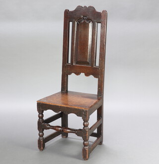 An 18th Century oak hall chair with arch panelled back and solid seat, raised on turned and block supports 115cm h x 45cm x 38cm 