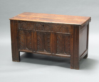 A 17th/18th Century carved oak coffer of panelled construction with hinged lid 62cm h x 105cm w x 49cm d 
