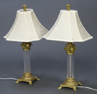 A pair of gilt metal and beaded glass table lamps in the form of columns with Corinthian capitals and shaped white shades 55cm h 