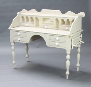 A Victorian style white painted pine writing table with raised super structure to the back fitted pigeon holes and 3 short drawers, the base fitted 4 short drawers raised on turned supports 109cm h x 126cm x 52cm d 
