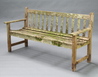 A well weathered slatted hardwood garden bench 81cm h x 154cm w x 56cm d (seat 129cm x 36cm) 
