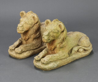 A pair of well weathered concrete garden figures of seated lions 34cm h x 52cm w x 22cm d 
