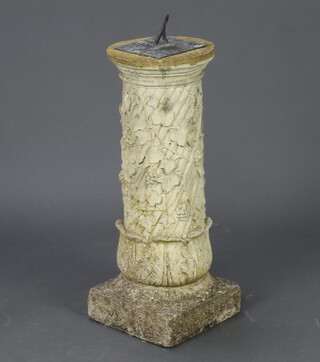 A verdigris metal sundial, raised on a well weathered concrete pedestal with ivy and vinous decoration, 66cm h x 24cm diam. 