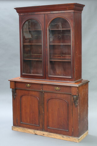 A Victorian mahogany bookcase with moulded cornice, fitted adjustable shelves enclosed by arch panelled doors, raised on an associated base fitted 2 drawers enclosed by pair of arch panelled doors 109cm h x 120cm w x 45cm d 