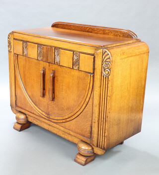 A 1930's Art Deco carved oak and ply sideboard with raised back, fitted a shelf and 2 drawers enclosed by pair of panelled doors, raised on bun feet 100cm h x 120 w x 49cm d 