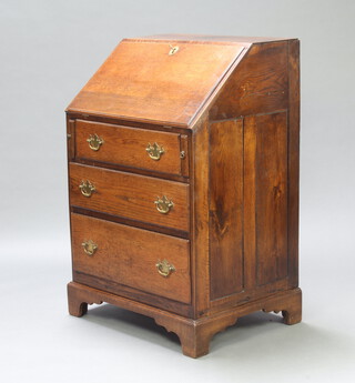 An 18th/19th Century oak bureau the fall front revealing a well fitted interior above 3 long drawers 105cm h x 68cm x 55cm d 