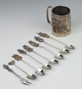 A white metal repousse mug decorated with a vacant cartouche together with 6 925 standard spoons and 2 other items