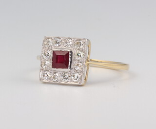 A yellow metal stamped 18ct Art Deco style ruby and diamond ring, the centre stone 0.4ct surrounded by brilliant cut diamonds 0.35ct 1.9 grams, size O 