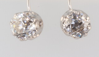 A pair of white metal mine cut diamond earrings, each approx. 0.4ct