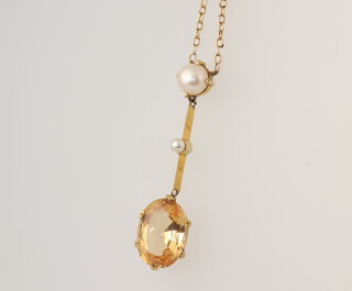 A yellow metal oval citrine and pearl pendant 4cm on a 45cm 9ct yellow gold chain, gross weight 4 grams 