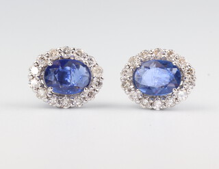 A pair of white metal stamped 18ct oval sapphire and diamond ear studs, the sapphires 1.61ct, the diamonds 0.54ct, 3 grams, 10mm x 8mm 