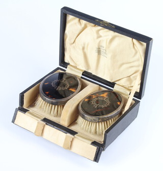 A pair of silver and tortoiseshell hair brushes boxed, London 1926 
