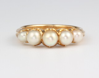 A yellow metal 5 stone pearl ring 5 grams, size P 