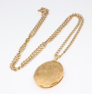 An oval 18ct yellow gold engraved locket 9.3 grams gross together with a 9ct yellow gold chain 53cm, 6.6 grams