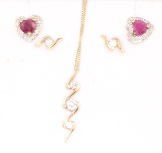 A pair of yellow metal ruby and diamond ear studs, a pair of 9ct paste studs and a 9ct yellow gold paste set necklace 