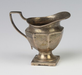 An octagonal silver cream jug on a square base Birmingham 1938, 7.5cm 