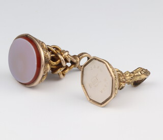 A 19th Century gilt carnelian seal, an octagonal ditto with a carved crest 