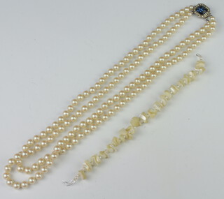 An imitation pearl double strand necklace, a shell bracelet 