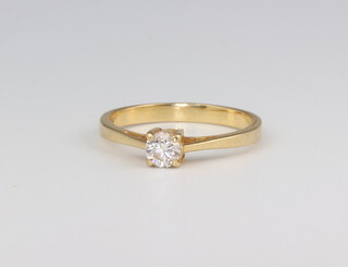 A yellow metal 750 single stone diamond ring approx. 0.25ct, size L 1/2, 2.2 grams 
