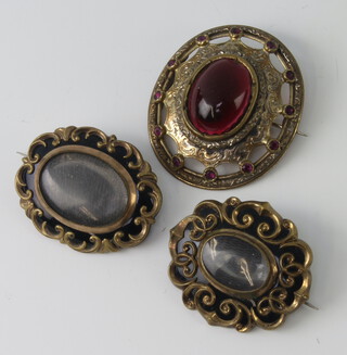 Two 19th Century gilt in memoriam brooches and a cabochon cut gilt brooch 