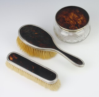 A silver and tortoiseshell dressing table set comprising powder jar, hair brush, clothes brush, London 1930 