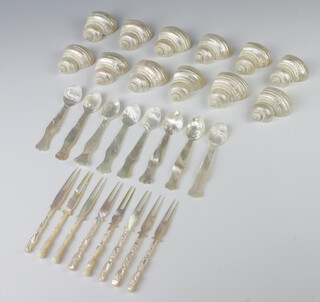 A quantity of carved mother of pearl handled cutlery and ditto shell napkin holders