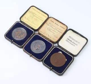 Two silver commemorative medallions London Gardens Guild Exhibition 60 grams and a bronze ditto, cased 