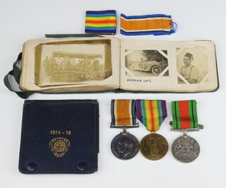 A First World War pair of medals to M2/229810 Pte.G.W. Earl ASC, together with a Defence medal, a British Legion holder and an album of related First World War photographs 