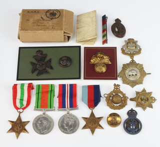 A group of Second World War medals comprising 1939-45 Star and Italy Star, Defence and War medal with original posting box to B Wright together with associated Second World War cap badges   