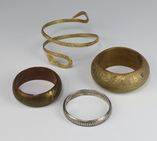 An Eastern brass bangle and 3 others