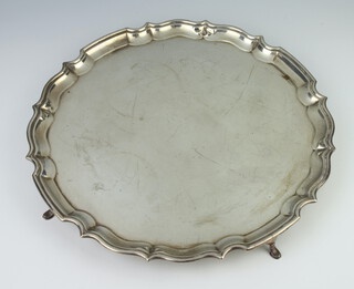 A silver salver with pie crust rim on pad feet, Chester 1913, 30cm, 840 grams 
