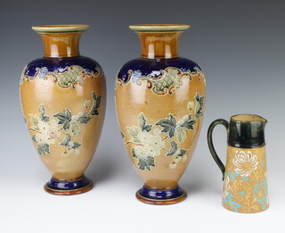 A pair of Royal Doulton salt glazed vases with floral decoration impressed 4841 34cm (one f and r to the base) together with a circular green salt glazed jug 17cm 