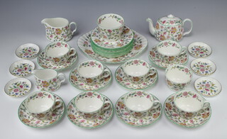 A 36 piece Haddon Hall tea service comprising twin handled plate, 8 tea plates, 8 tea cups (1 possibly a 2nd), 8 saucers (1 with slight firing imperfection to base), large milk jug, small milk jug, large sugar bowl, small sugar bowl, small teapot and 6 small butter dishes 