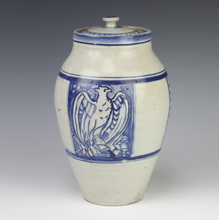 A Continental Art Pottery blue glazed urn and cover decorated a phoenix, the base indistinctly impressed 29cm 