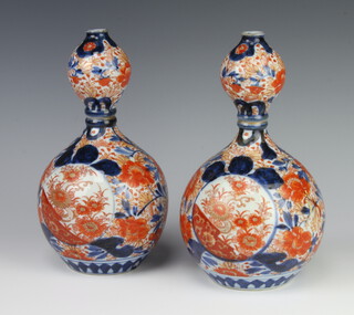A pair of 19th Century Japanese Imari double gourd shaped vases with panelled decoration 26cm 
