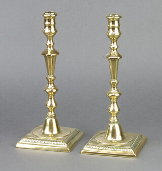 A pair of Georgian polished brass candlesticks raised on square bases 28cm h x 11cm x 11cm 