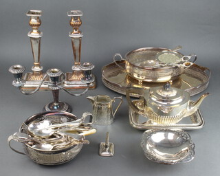 An oval pierced galleried tray 40cm, a pair of tapered candlesticks and minor plated wares