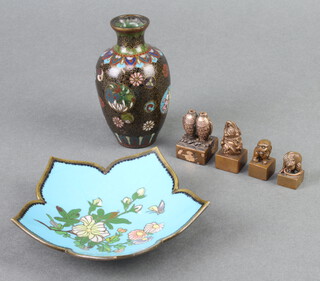 A black ground and floral patterned cloisonne club shaped vase 9cm x 2cm (chip and section missing to the shoulder), a cloisonne enamelled leaf shaped dish decorated flowers and butterfly 10cm x 11cm (some crazing), together with 4 Eastern bronze seals 3cm x 2cm x 2cm 