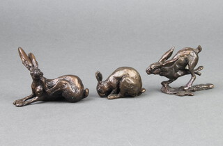 In the manner of Richard Cooper & Co., a bronze figure of a crouching rabbit, the back marked PJ 3cm x 5cm x 2cm and a bronze figure of a seated scratching hare base marked PJ 6cm x 7cm x 3cm and a limited edition bronze figure of a running hare base marked MS 217250 5cm x 7cm x 3cm 
