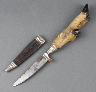 W Clauberg, a dirk with 9.5cm blade marked 7000, with deer's foot grip and complete with leather scabbard 26cm overall 