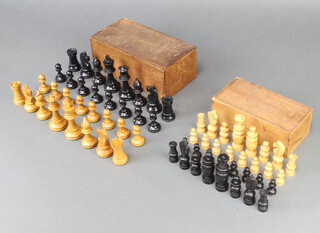 A wooden Staunton chess set (1 white pawn has crack to top, 1 black pawn has split, black bishop split to base, the other with damage to turning) together with a turned wooden St George's pattern chess set (2 black knights have been stuck, split to bishop, 1 black pawn and 1 white pawn has turning damaged to base, white knights are stuck)  